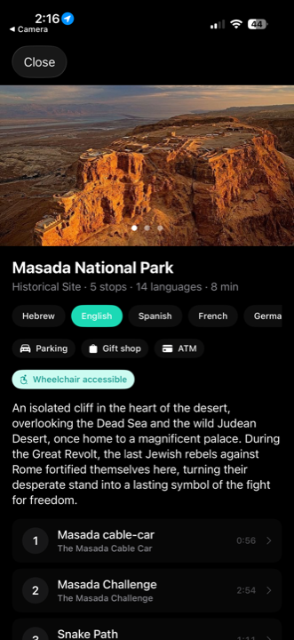 Wexplo site guide on a phone showing Masada National Park overview with 5 numbered stops and 14 language options
